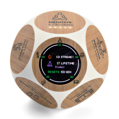 Wooden wellness tracker with meditation timer display, showing 1D streak and 17 lifetime student sessions with reset information on central screen.