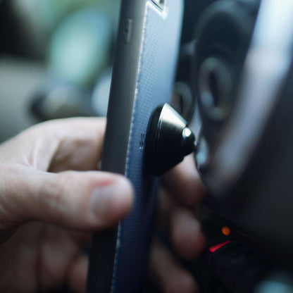 SafeSleeve car mount attached to smartphone case, close-up side view showing magnetic connection detail.