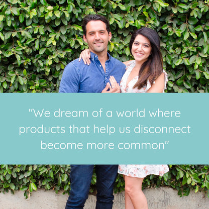 Couple smiling outdoors against ivy backdrop with quote about disconnecting from technology products.