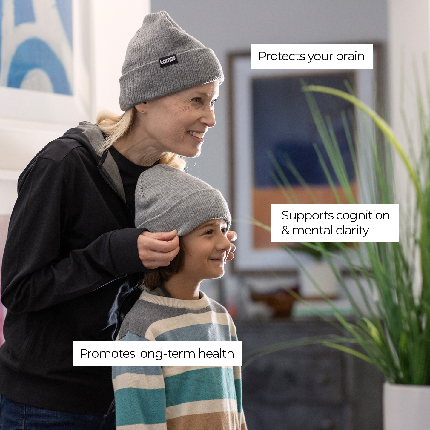 Woman and child wearing gray HAVN WaveStopper™ Beanies indoors with text highlighting brain protection, cognition support, and long-term health benefits.