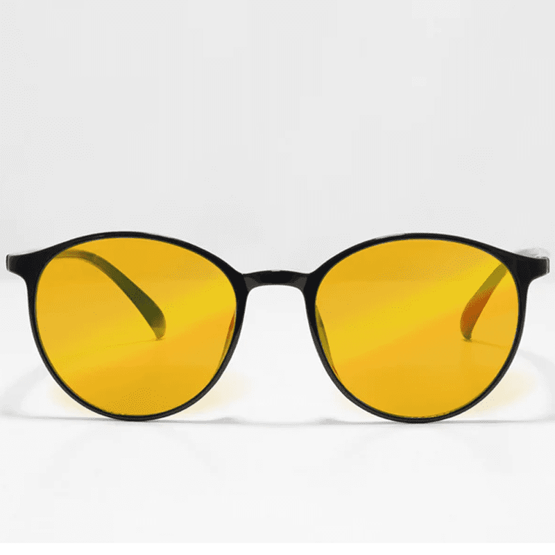 Ocushield Amber blue light glasses with round black frames and yellow-tinted lenses, front view against white background.