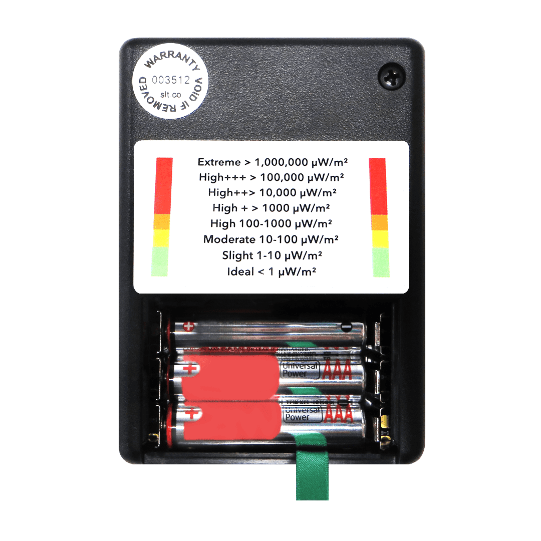 SLT Safe and Sound Classic III EMF meter showing battery compartment with four AA batteries and UV exposure scale chart ranging from ideal to extreme levels.