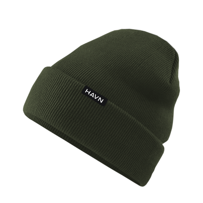HAVN WaveStopper™ Beanie in olive green, displayed at an angle showing the ribbed knit texture and white brand label on the front.