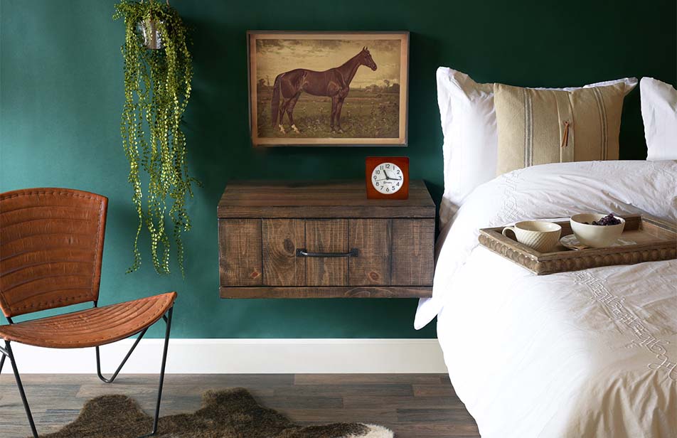 Bagby EMF-Free Classic Silent Analog Alarm Clock displayed on wooden nightstand in modern bedroom with teal walls.