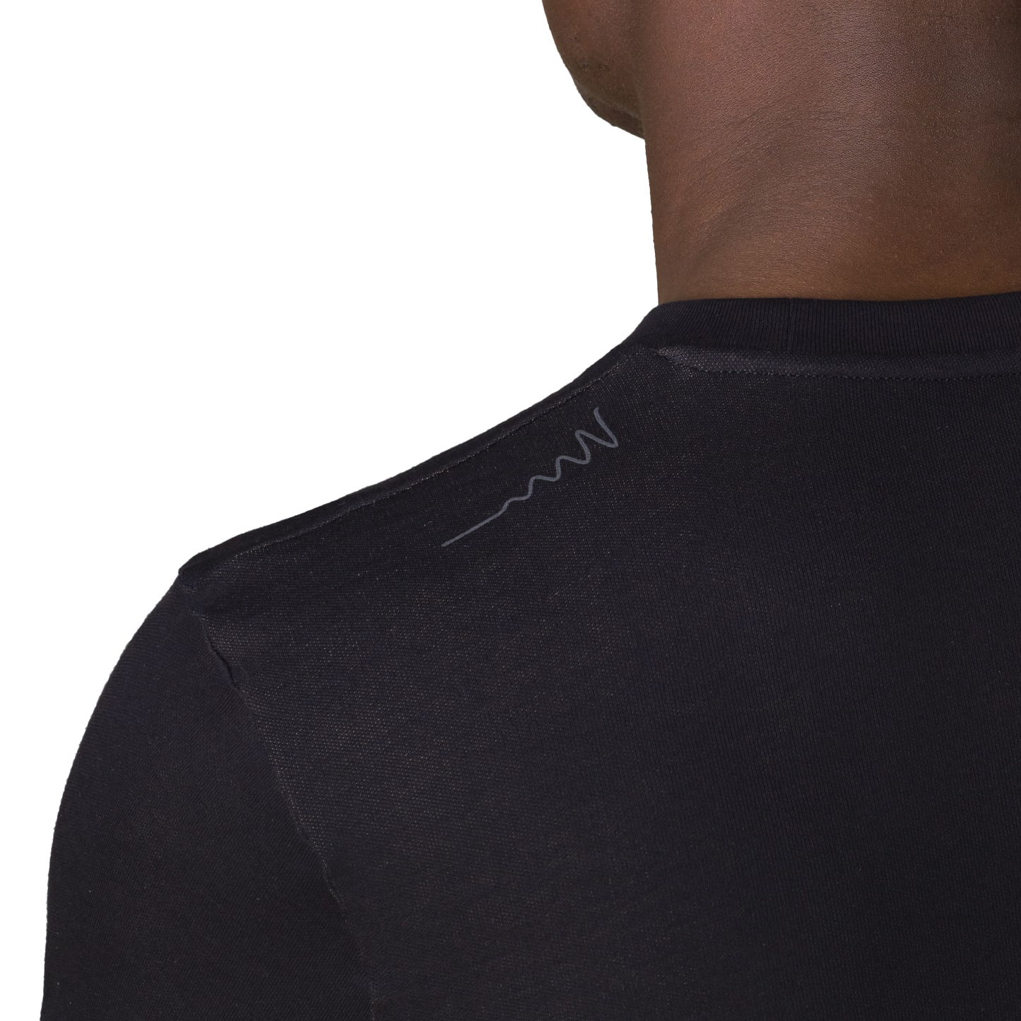 Close-up back view of HAVN WaveStopper T-Shirt 2.0 showing shoulder seam detail and subtle logo on black fabric.