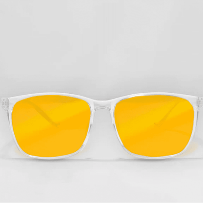 Ocushield Amber blue light glasses with clear frame and bright yellow lenses, front view against gray background.