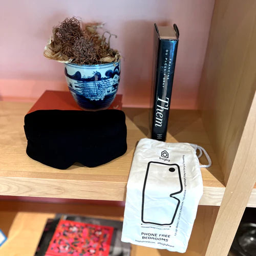 Bagby Better Bedroom Bundle displayed on wooden shelf with black eye mask, blue succulent planter, book, and phone pouch.