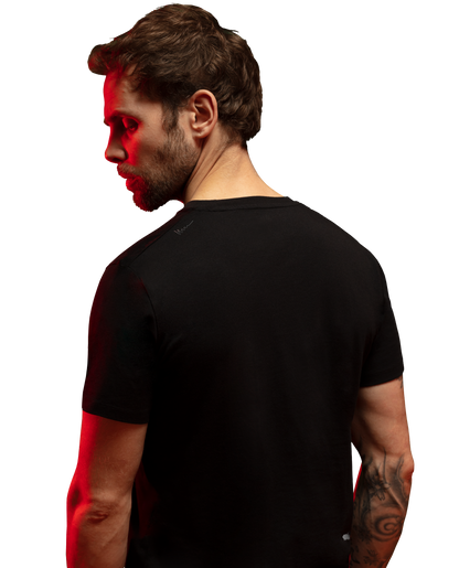 Man wearing black HAVN WaveStopper™ T-Shirt 2.0 shown from side profile with red light overlay effect.