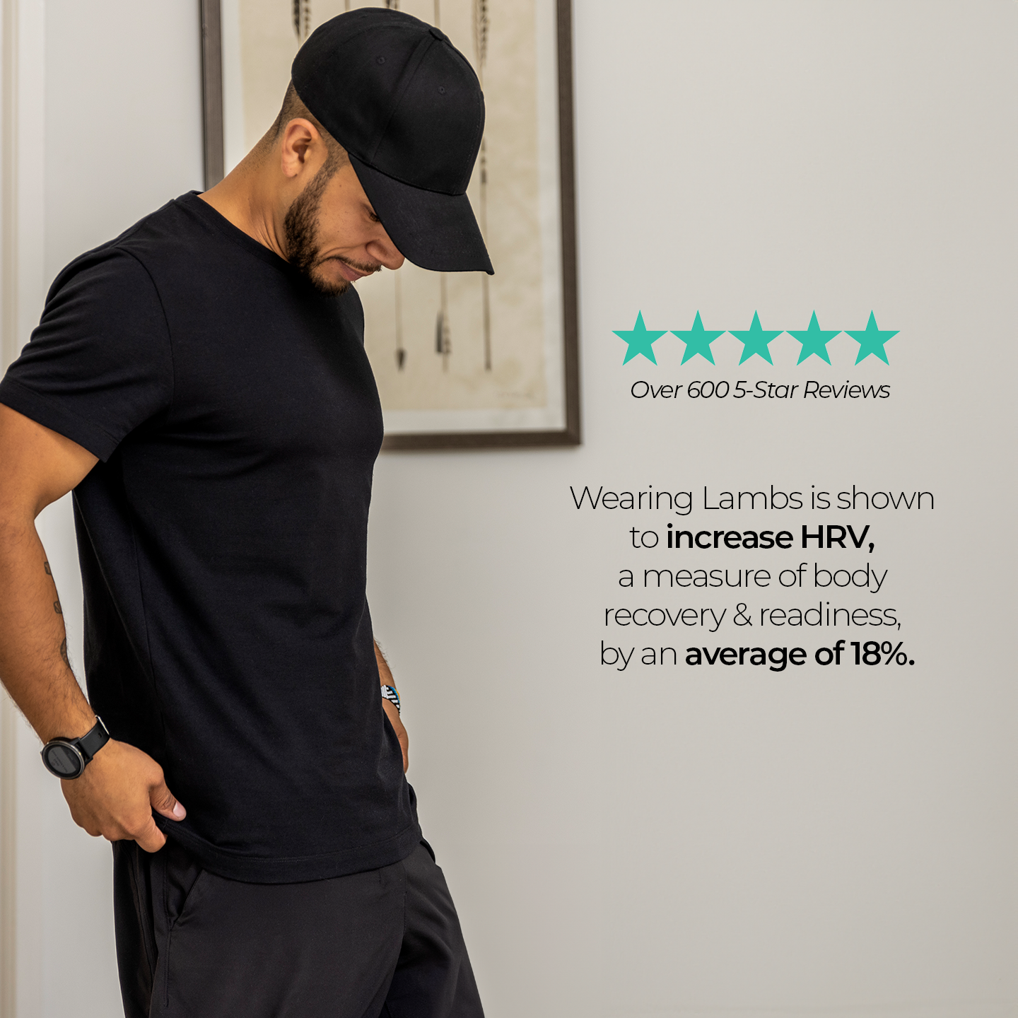 Man wearing black HAVN WaveStopper T-Shirt 2.0 and cap, shown from side profile with arms at rest, displaying fit and fabric.