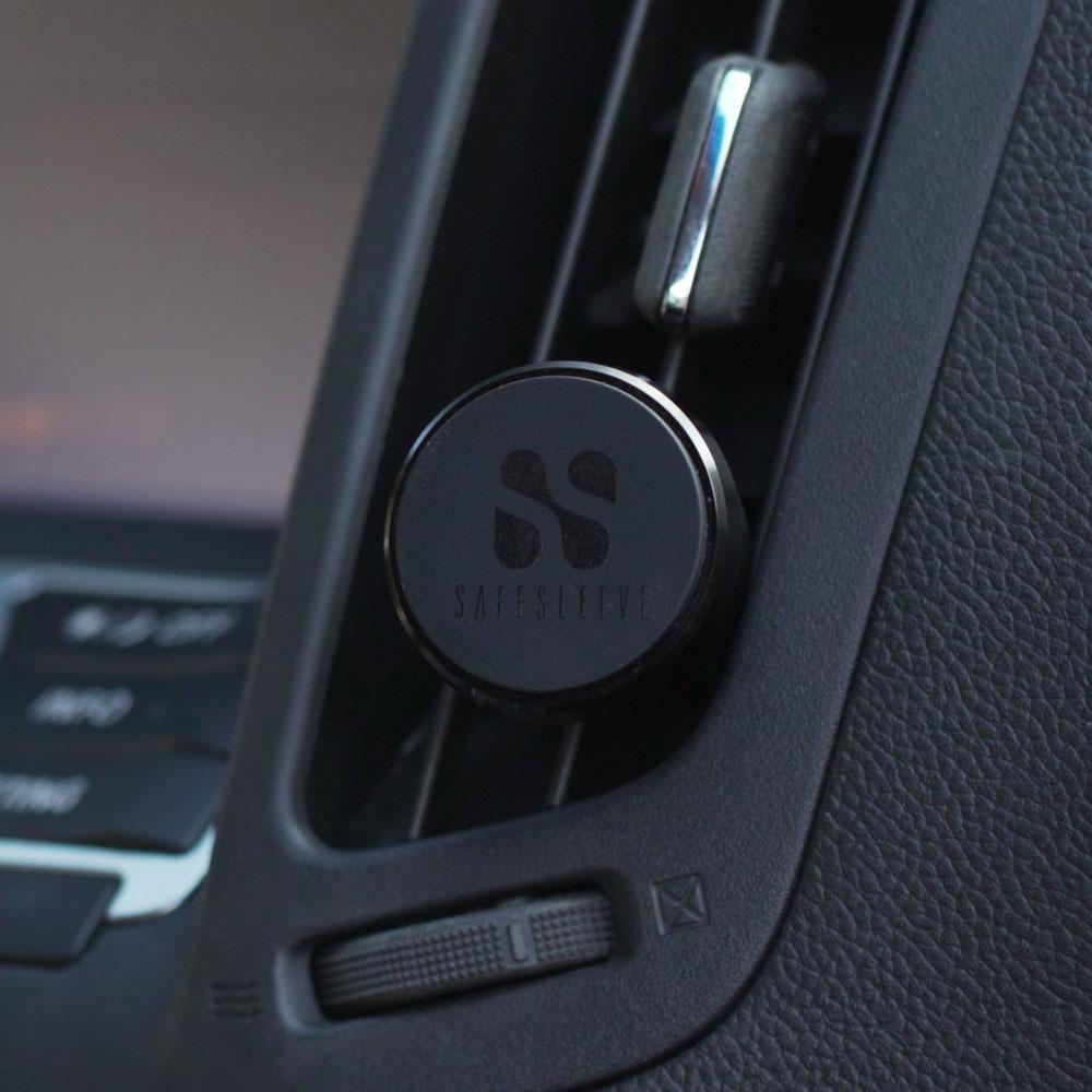 SafeSleeve car mount with circular magnetic plate attached to vehicle air vent, showing logo detail.