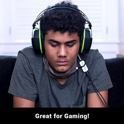 Young person wearing black gaming headset with green accents and microphone, looking down, demonstrating SYB H.A.R.D. headset in use.