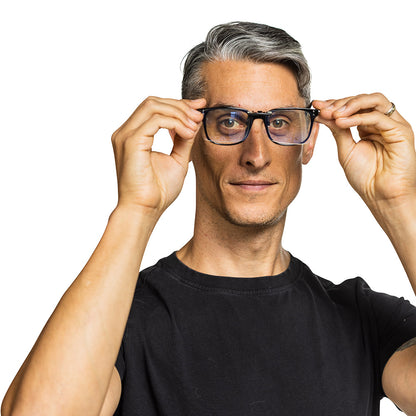 Man wearing black SYB Clip-On Bluelight Glasses with dark frames, adjusting them with both hands against white background.
