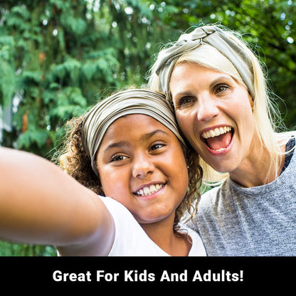 Woman and child wearing SYB Neck Gaiter headbands outdoors, smiling at camera with green foliage background.