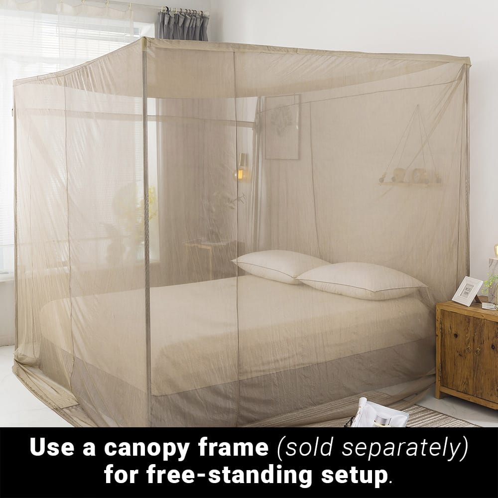 SYB Faraday Bed Canopy draped over queen bed with two pillows, demonstrating free-standing setup over canopy frame in bedroom.