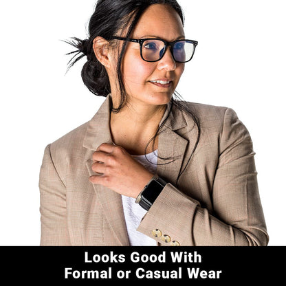 Woman wearing beige blazer and SYB Wrist Band on wrist, smiling while looking to the side against white background.